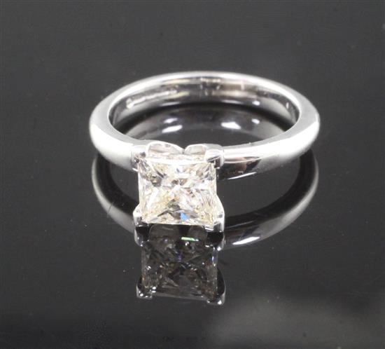 A modern 18ct white gold and solitaire princess cut diamond ring, size M.